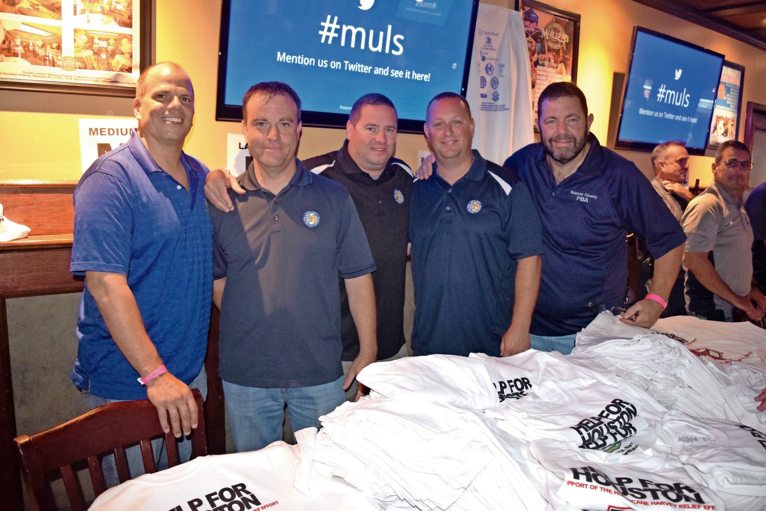Police Benevolent Association members sold T-shirts and raffles to raise money for Help For Houston at Mulcahy’s in Wantagh.