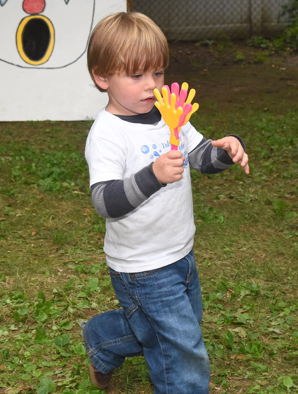 Grabbing one of the many toys handed out and sold at the festival, two-year-old Luke Kraus entertained himself.