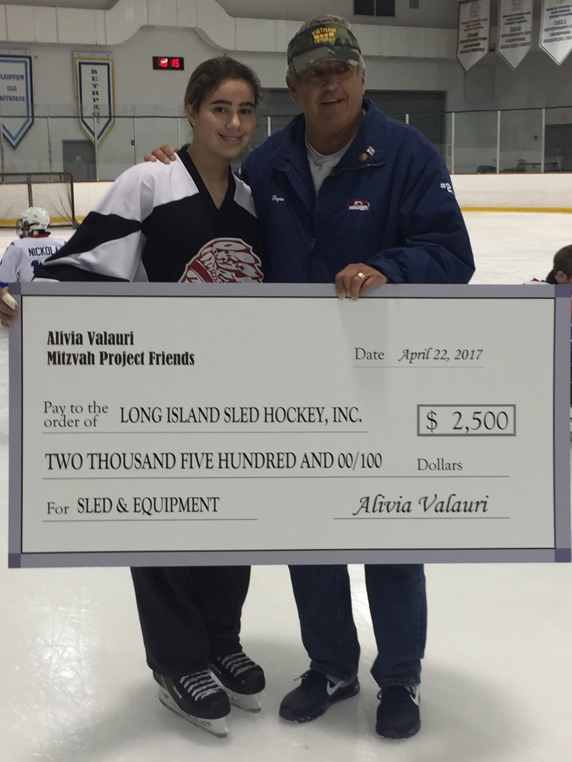 Bryan Blomquist, right, regularly raises money for Long Island Sled Hockey. Volunteer Alivia Valauri, 12, raised $2,500 on her own to help provide the team with sleds and equipment.