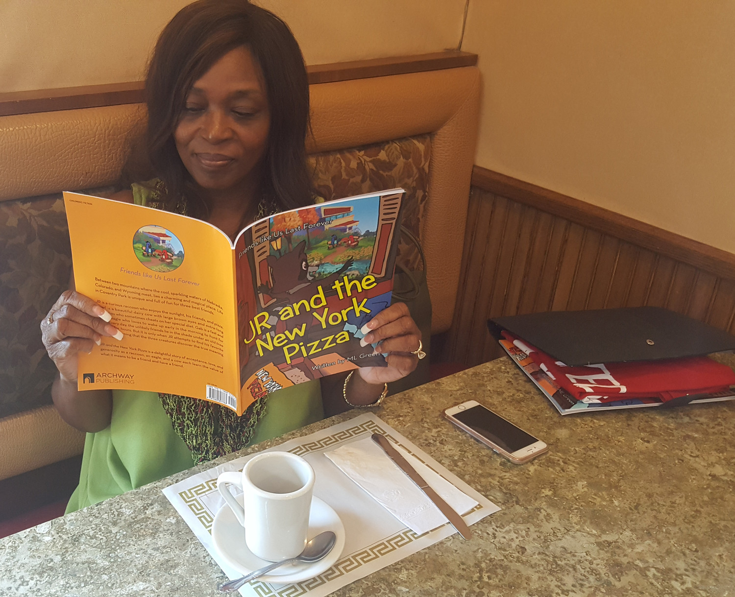 Freeport author ML Green leisurely read her new book, “JR and the New York Pizza” and planning to host more readings for children in Long Island.