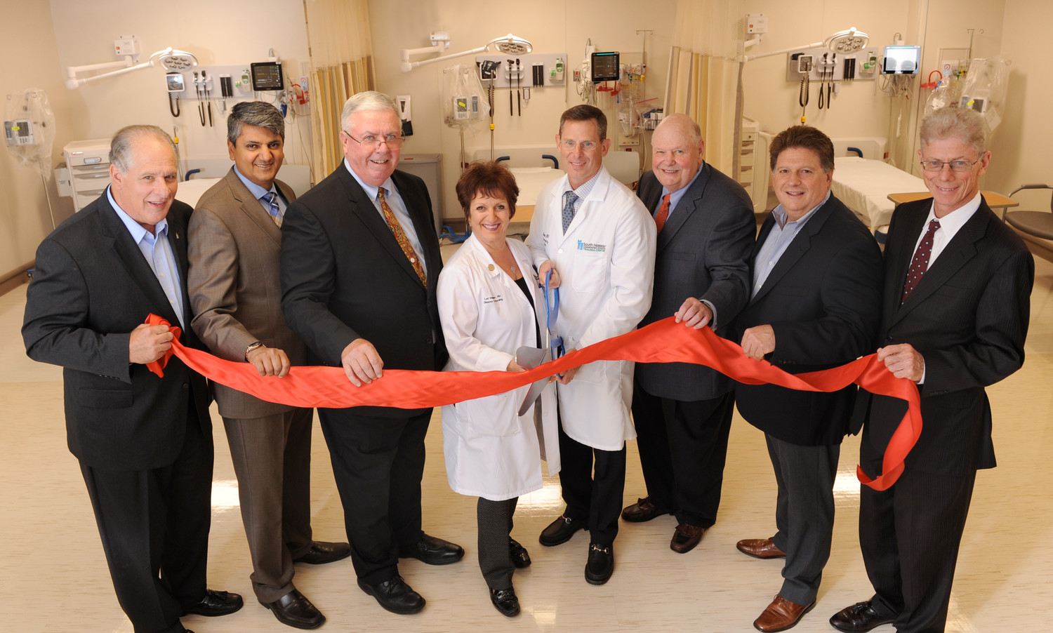 Tony Cancellieri, left, vice chair of the board of directors; Dr. Adhi Sharma, chief medical officer; Richard J. Murphy, president and chief executive officer; Lori Edelman, nurse director of Emergency Services; Dr. Joshua Kugler, chair of Emergency Services; Joseph Fennessy, chair of the board of directors; Joel Schneider, board member and chair of the Emergency Services Department Expansion Campaign; Bill Allison, senior vice president for administration and chief operating officer, at the ribbon cutting celebrating the opening of a new 10-bed treatment bay extension to South Nassau Communities Hospital’s Emergency Services Department.