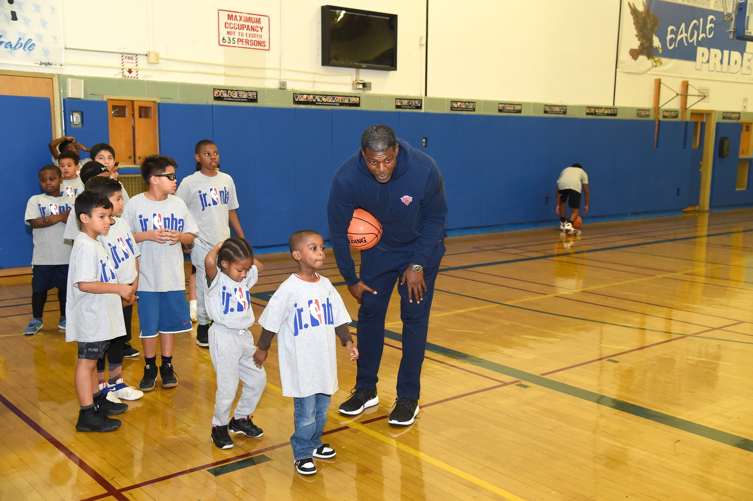 Former Knick Larry Johnson taught the more than 100 children who participated in the basketball clinic some layups.