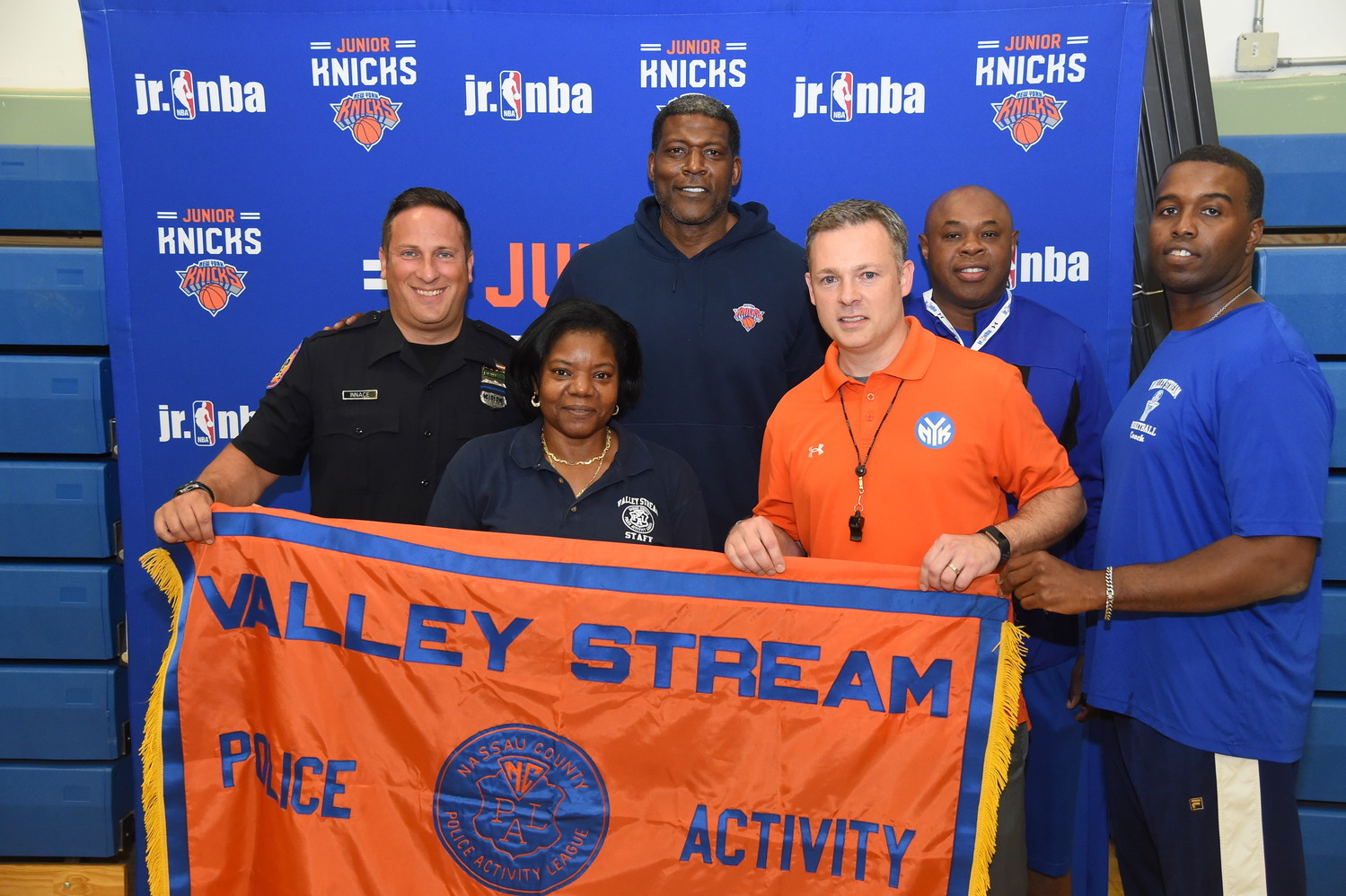 Police Activity League coaches and directors Chris Innace, Annette Gray-Thom, Steve Thom and Ramsey Jenkins applied for the Papa John’s Pizza Party and won a two-hour basketball clinic with Larry Johnson, third from left, and Knicks’ Director of Fan Experience Brendan Callahan, fourth from left.
