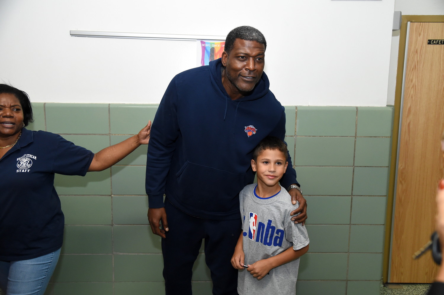 After the basketball clinic was over, kids such as 9-year-old Anthony Cantara lined up to take pictures with Larry Johnson.