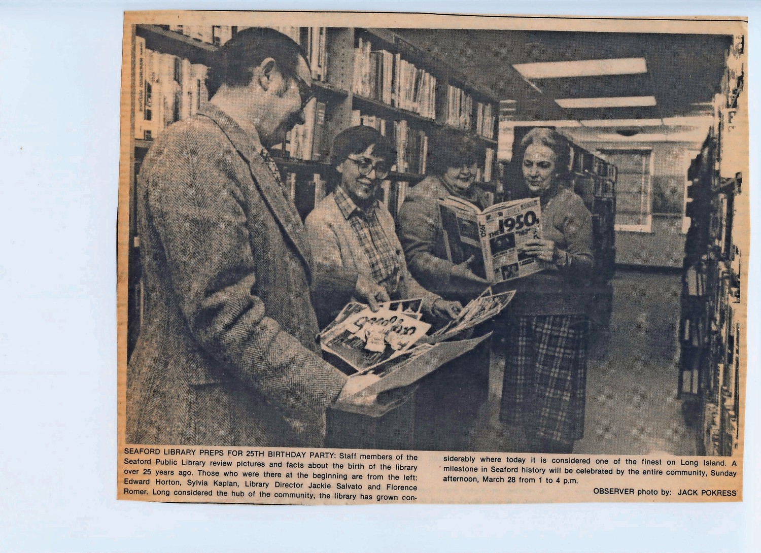 Edward Horton, Sylvia Kaplan, former Library Director Jacqueline Salvato and Florence Romer reviewed photos and facts about the library before its 25th birthday party.