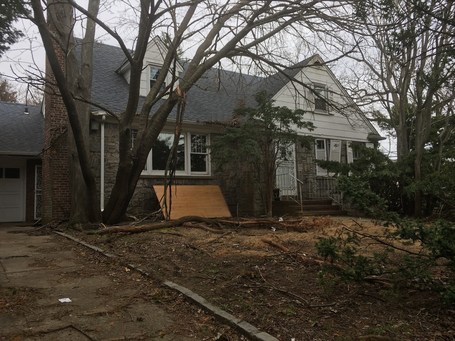 Plywood leans against the house’s walls and windows are smashed at 1 Wallace Court.