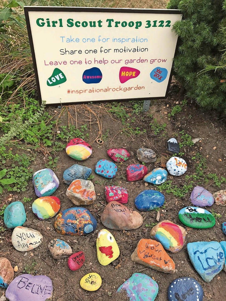 The stones in the garden are painted with inspirational and kind words.