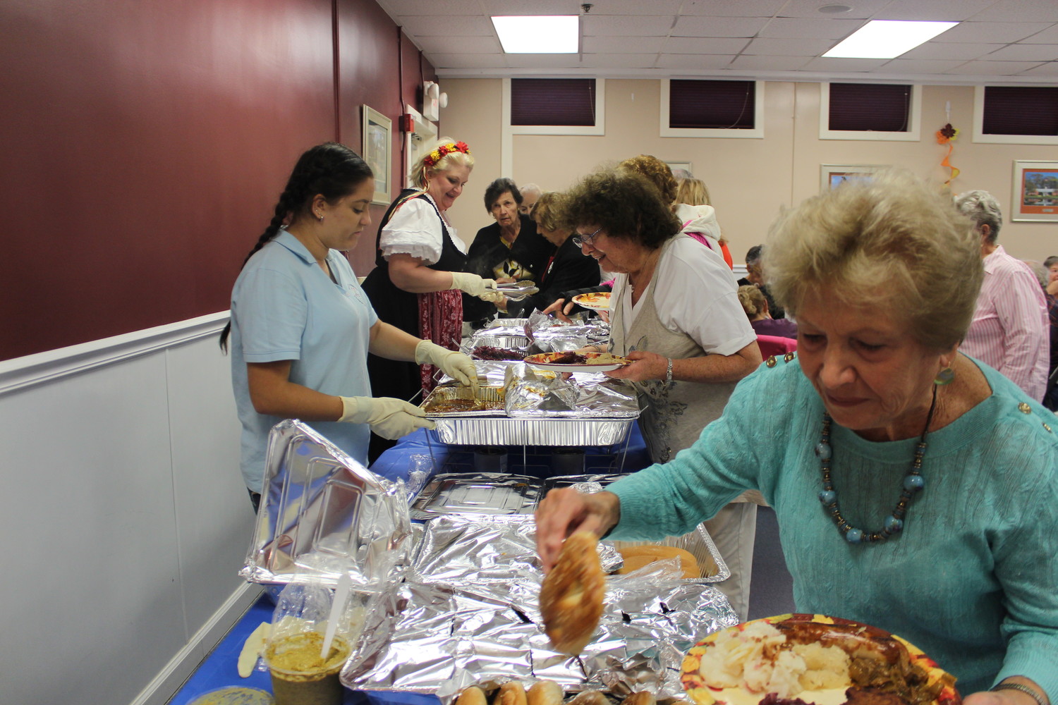 Oceania Diodato, left, and Ellen Wenz served German food to seniors.gural Oktoberfest on Oct. 25.