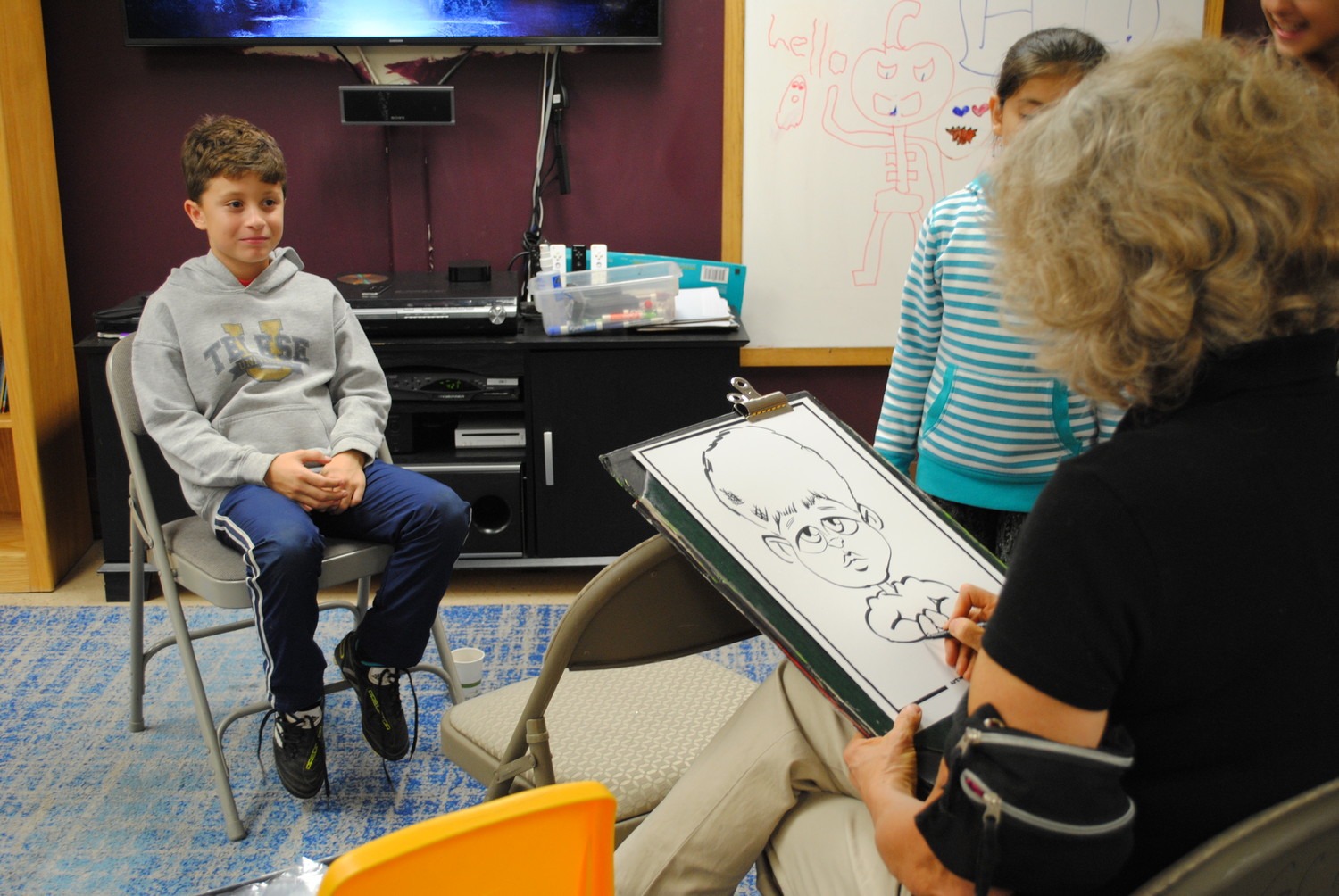 Michael Telese, 8, had his cartoon drawn by Alison of Alison G’s Fine Artwork at the Youth Bureau.
