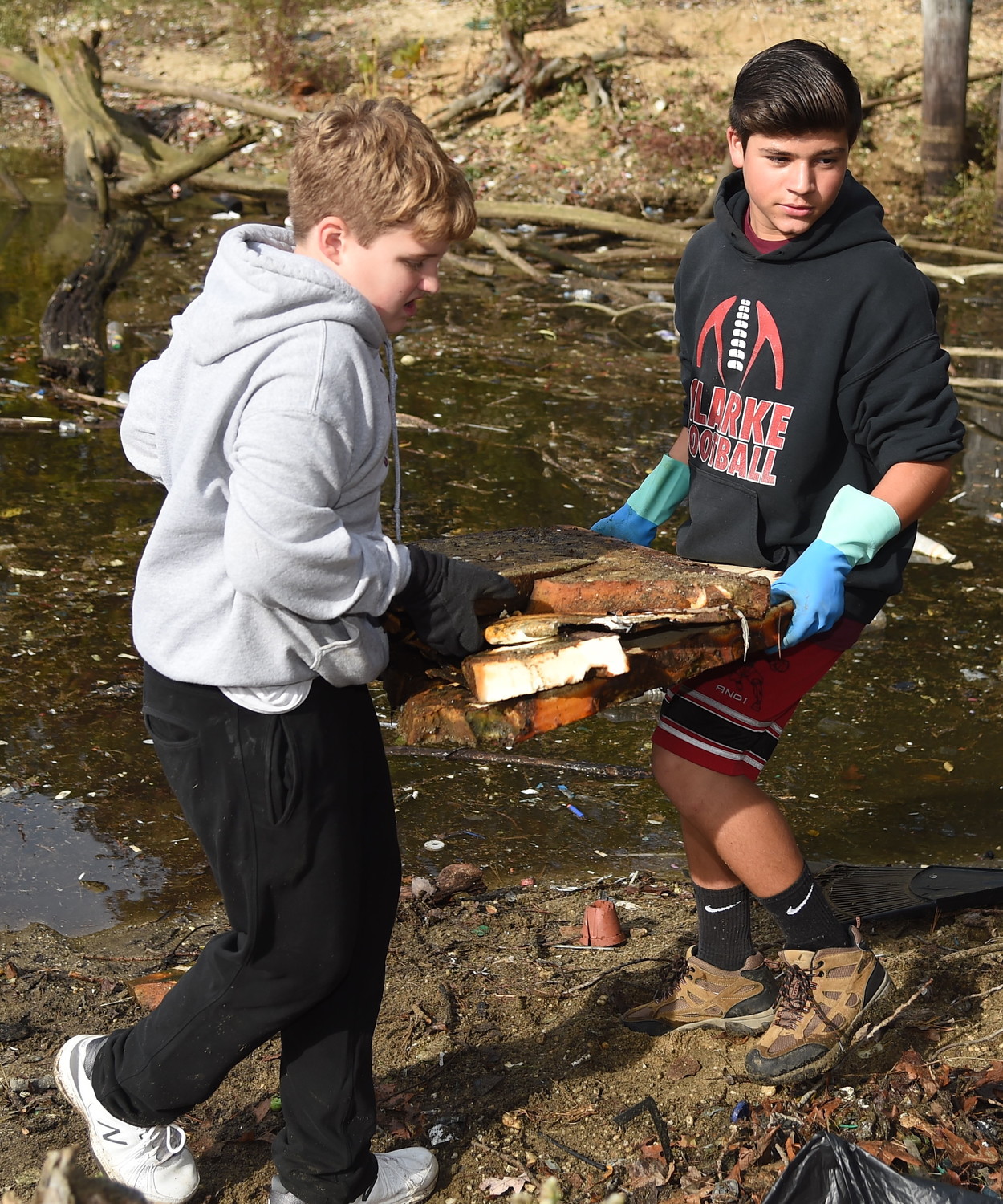 Robert Richard, 13, above, and Matt Anest, 14, carried large plastic disks that were decaying into the soil.