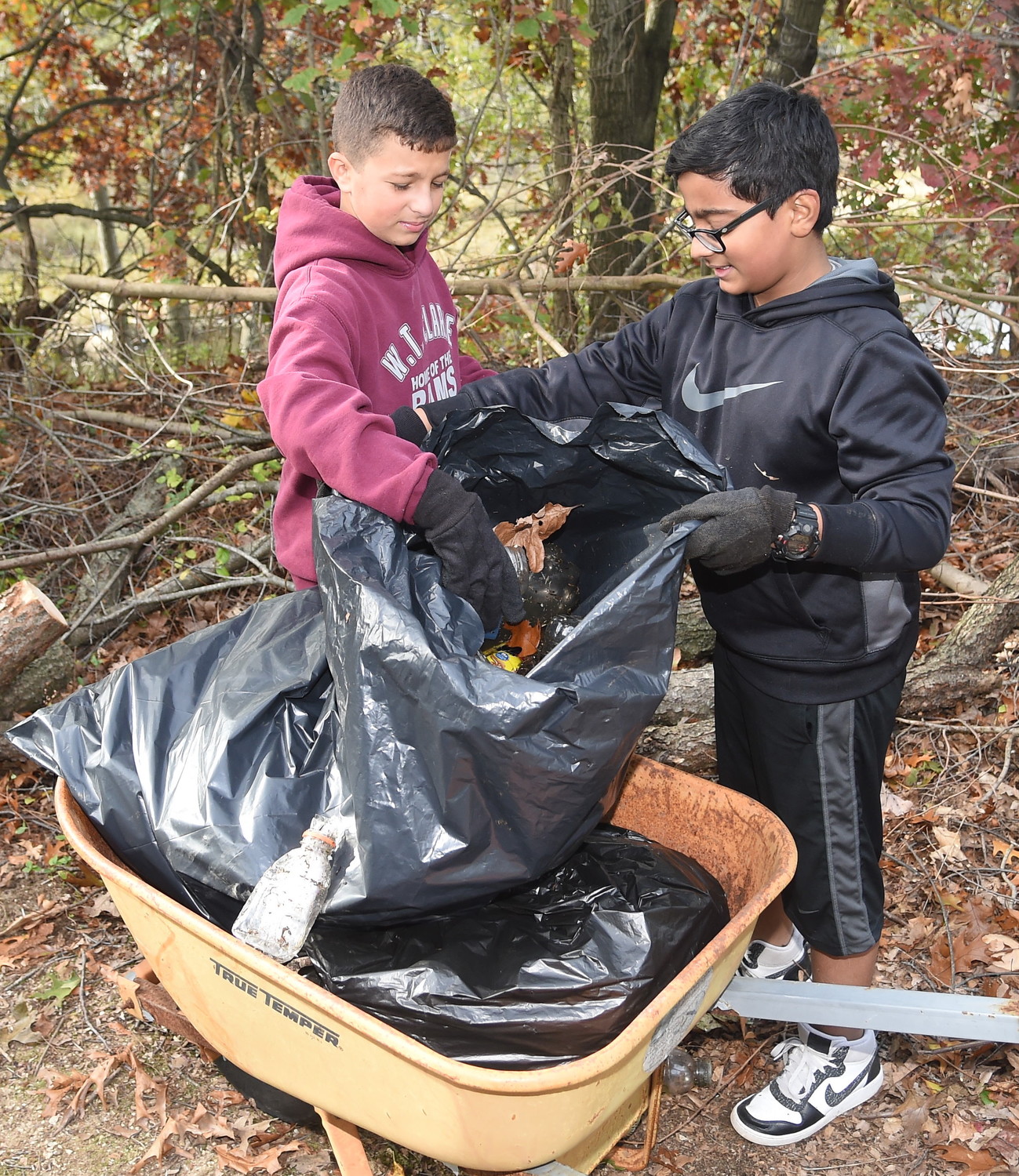 Antonio Palmeri and Sidd Chiguripati used a wheelbarrow to stuff garbage bags to the brim with as much litter as possible.