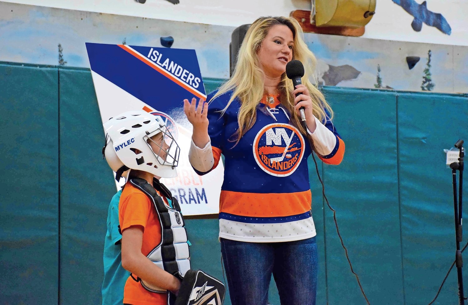 Dina Tsiorvas, a representative from the New York Islanders, spoke about teamwork while third-grader Victoria Boccil looked on.