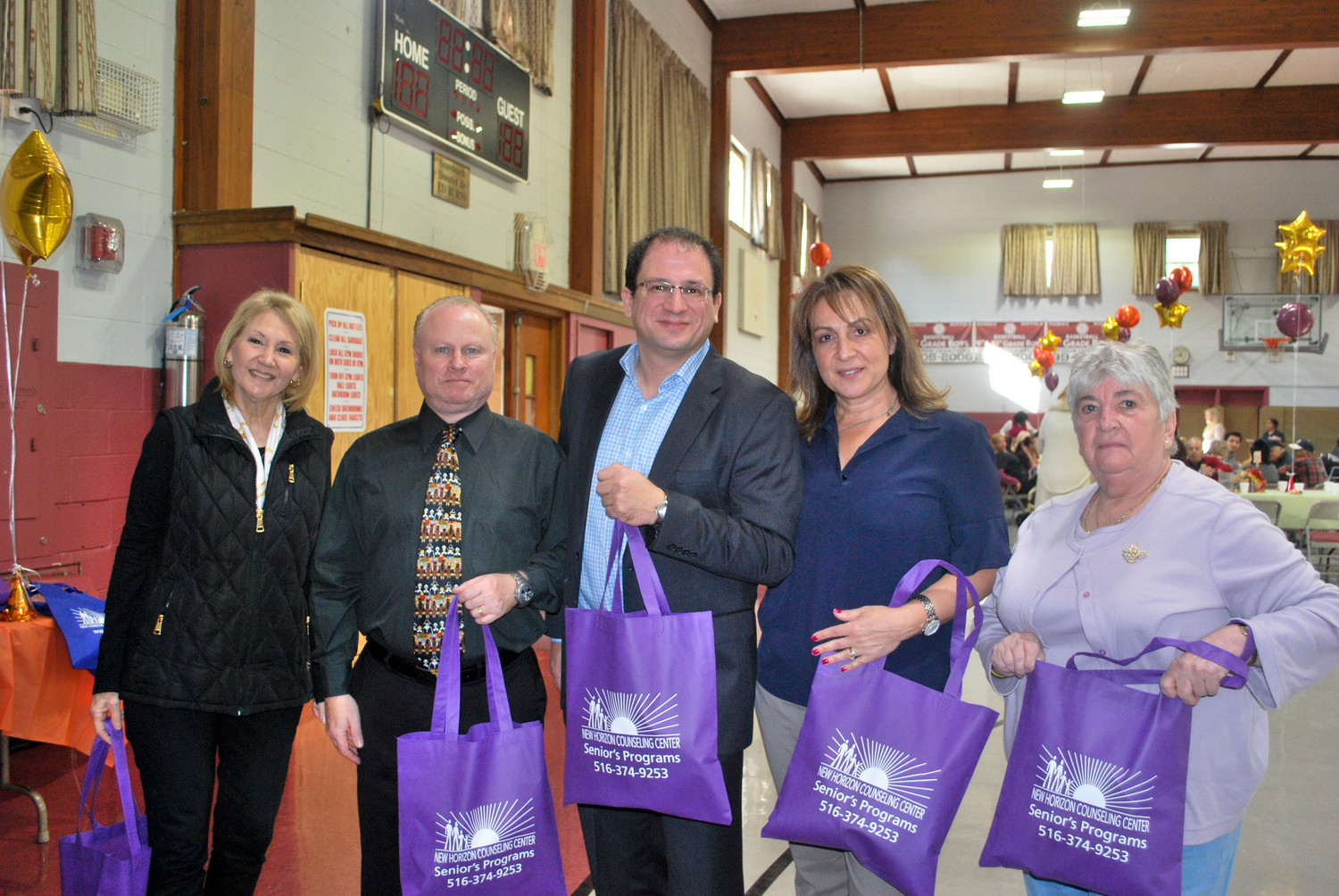 New Horizons Counseling Center handed out party favors at the holiday lunch. From left were Community Relations Coordinator Audrey Goodman, Assistant Programs Director Robert Robinson, CEO Herrick Lipton, Chief Administrative Officer Sigal Mashall and Board Vice President Gery DiDomenico.