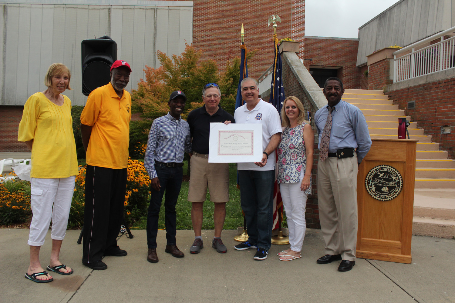 Debra Mulé is often seen at events throughout the community. Last summer she welcomed cadets from the U.S. Naval Academy. From left were Village Historian Cynthia King, school board Members Ernie Kight and Anthony Miller, Capt. Rick Robey, Deputy Mayor George Martinez, Mulé and village Trustee Ron Ellerbee.