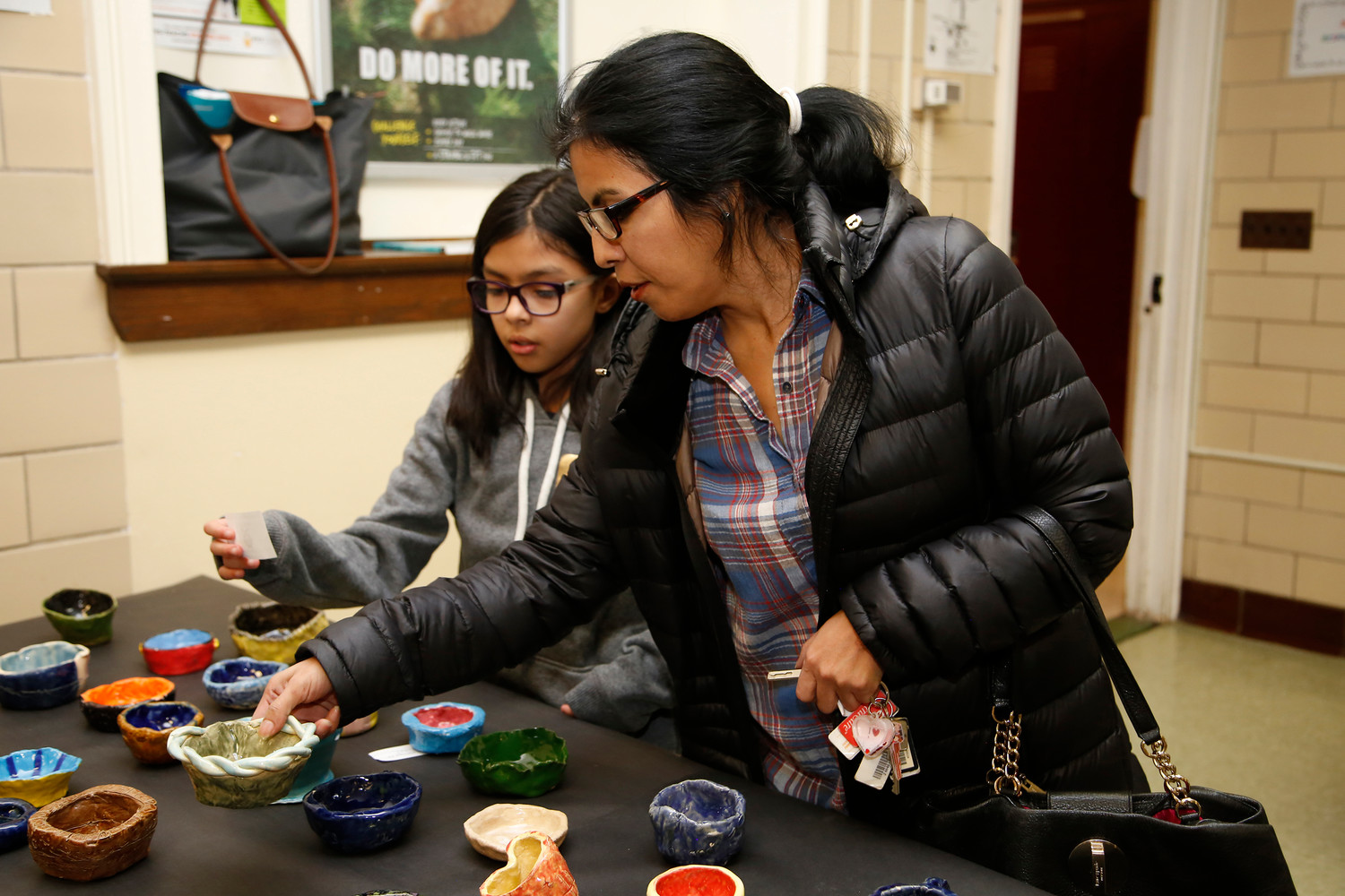 Emily Valdebenito, 9, and her mom, Ledda, picked out a handmade bowl at the Empty Bowls fundraiser on Nov. 30.