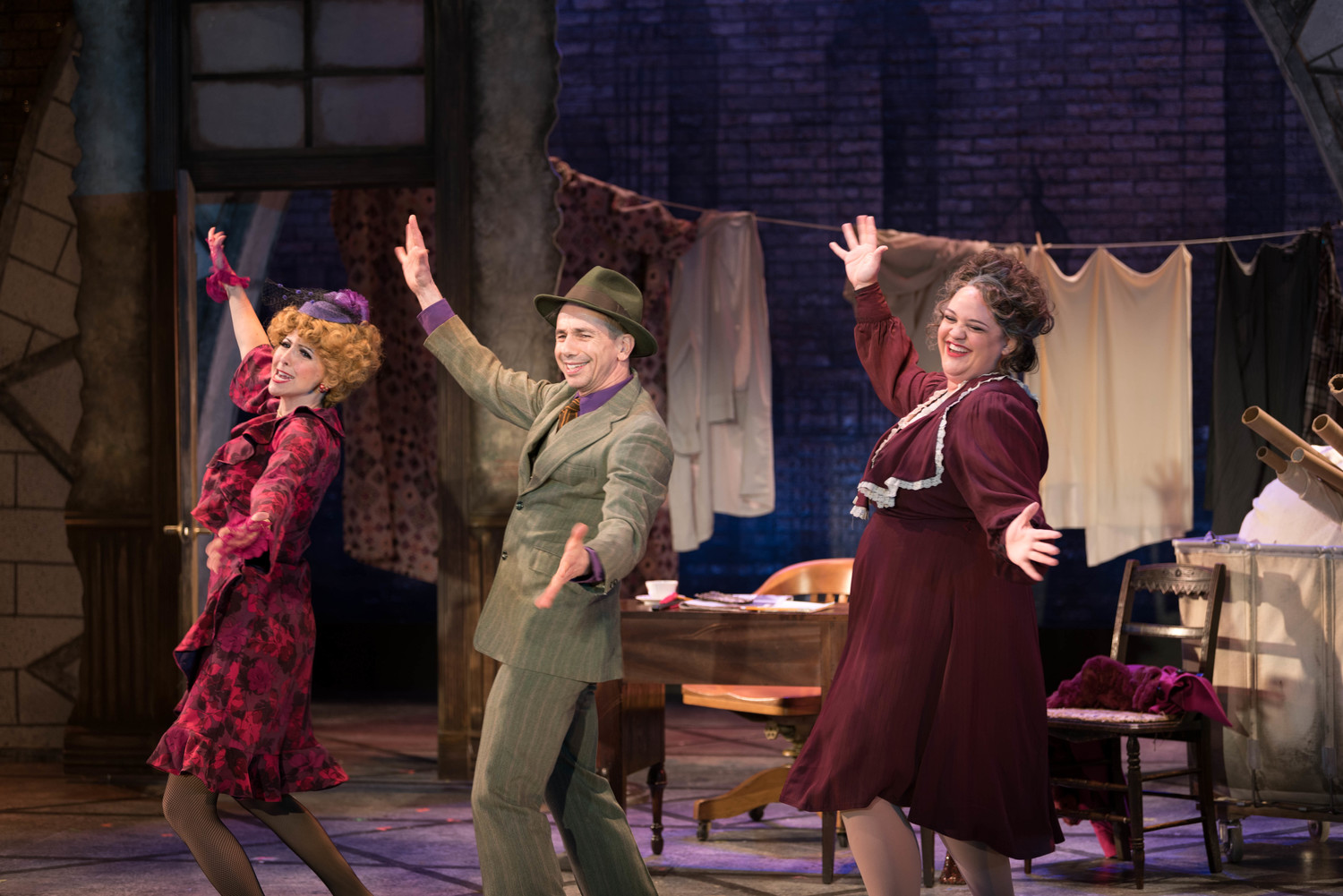 Gino Milo (Lily St. Regis), from left, Jon Peterson (Rooster) and Lynn Andrews (Miss Hannigan) in a scene from “Annie."