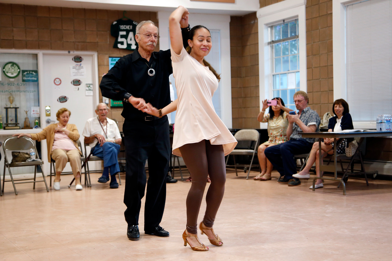 Guy Ferrara, above with dancing partner Karina Hernandez, led several free salsa dancing lessons for senior citizens in Valley Stream this year. His entertaining persona has earned him something of a cult following.