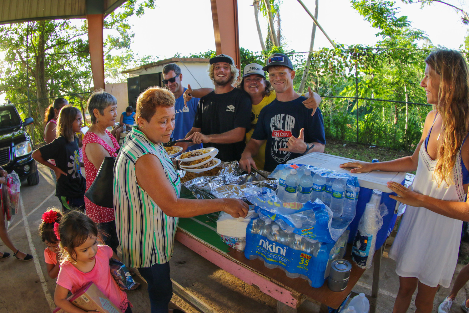 Woody Skudin, center, served food to residents with pro surfer and Montauk native Leif Engstrom, fourth from left, and other volunteers in Rincon, P.R., on Dec. 17.