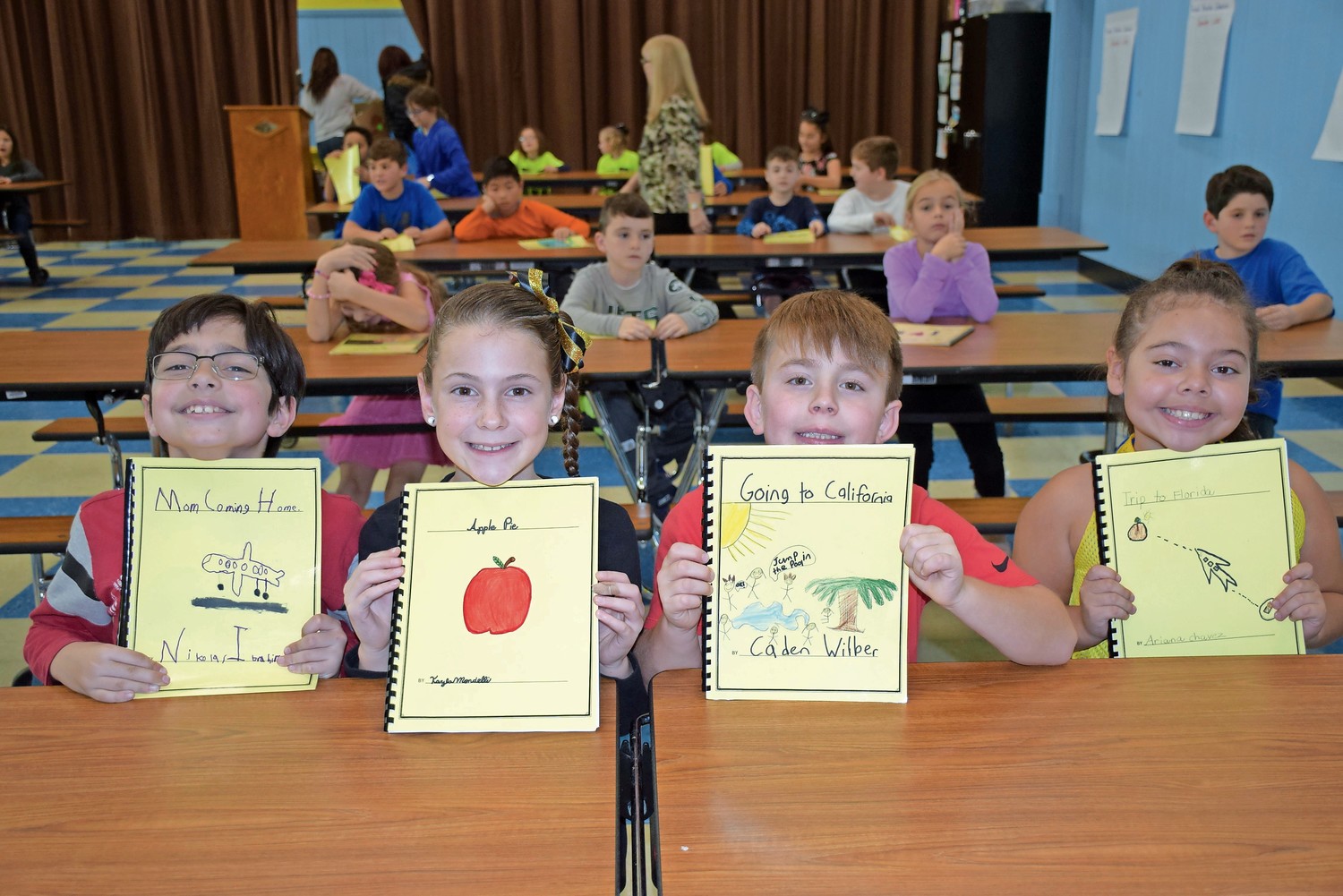 Mandalay Elementary School third-graders, from left, Nikolas Ibrahim, Kayla Mondelli, Caden Wilber and Ariana Chavez were proud to present their personal narrative writing projects during the Personal Writing Celebration.