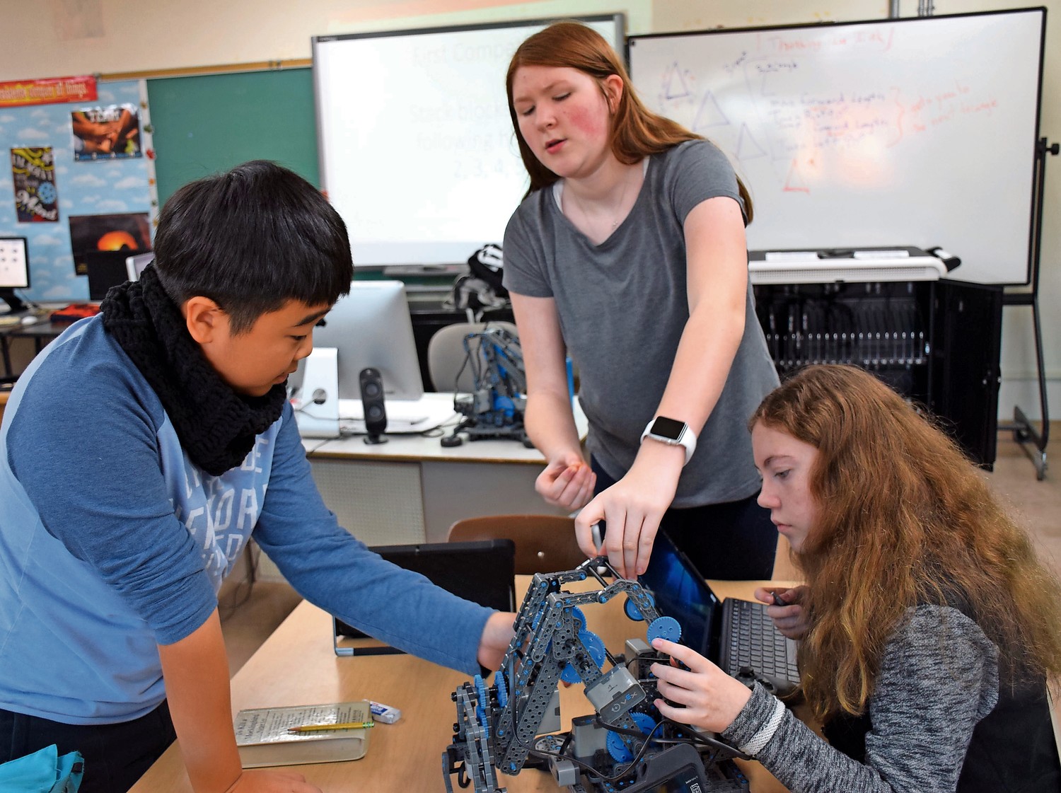 Hyosung Yang, Sabrina Joerg and Jessica Augustin, right, went to work building their latest robot.