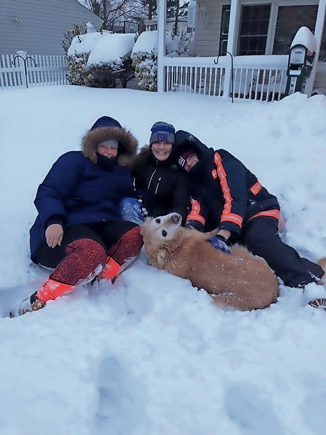 Samantha Cohen, left, Gabby Cohen and Max Cohen enjoyed playing in the snow with their golden retriever, Tasha, in Levittown.