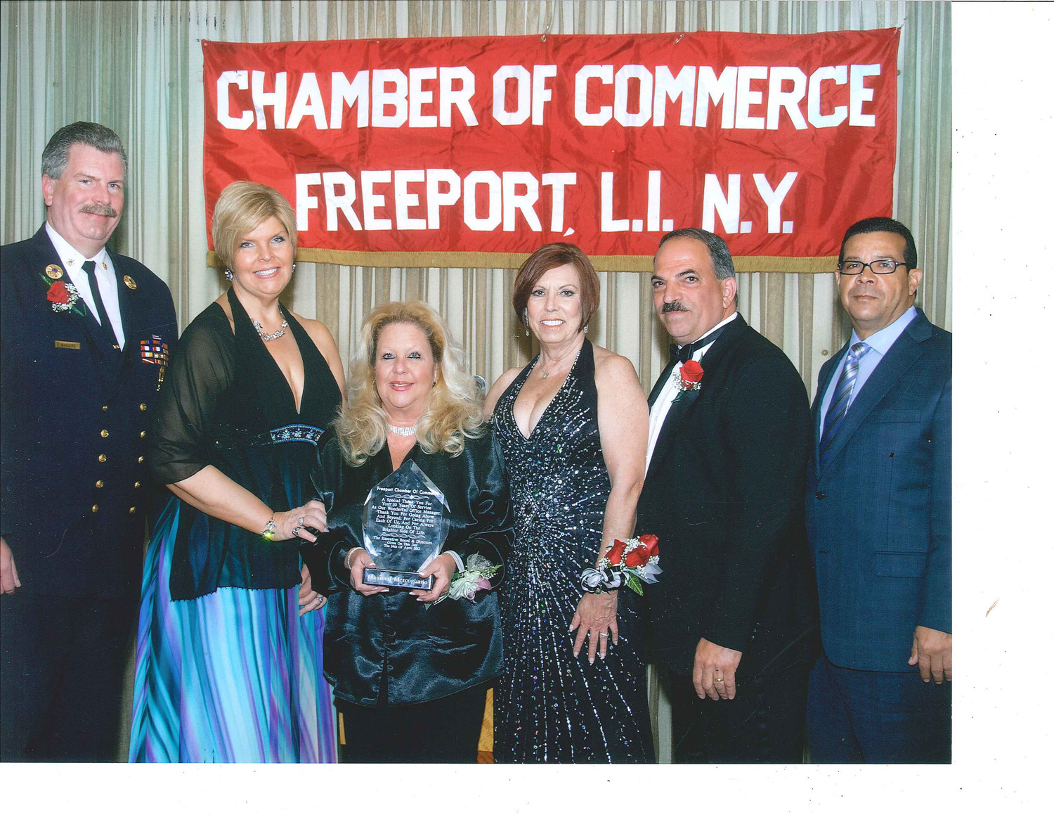 Maureen Mercogliano was given an award of recognition for 10 years of service to the Freeport Chamber of Commerce in 2011. From left were Ray Maguire, executive director of the Freeport Fire Department; Ilona Jagnow, owner of Otto’s Seagrill; Mercogliano, Jerri Quibell; former chamber President John Nuzzi; and Francisco Jorge.