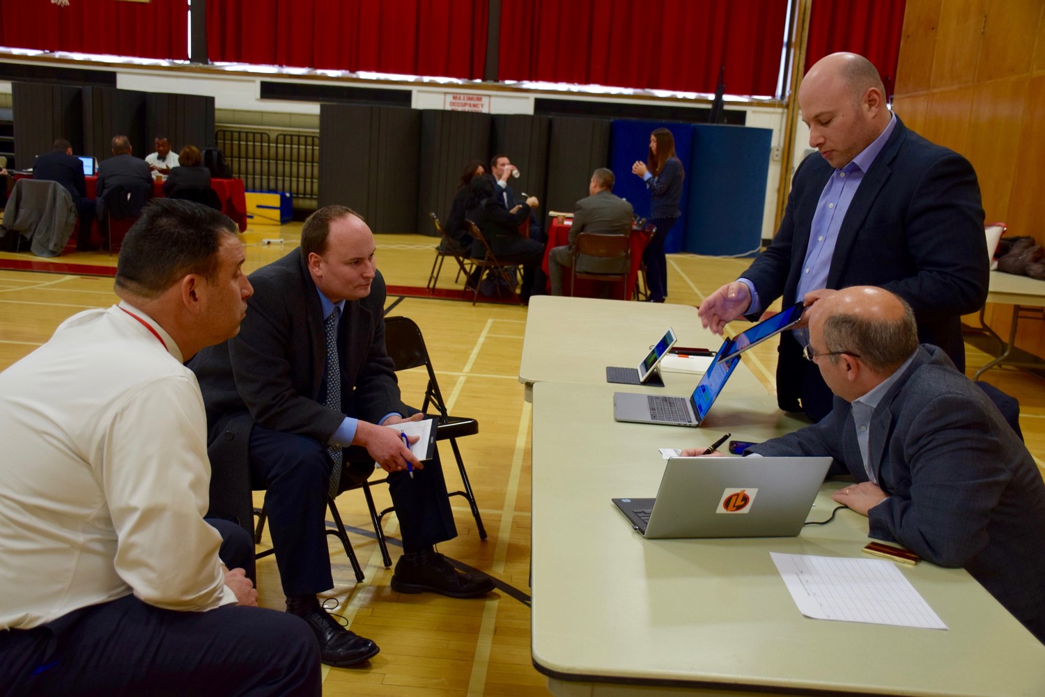 Josh Goldenberg of Legends of Learning, far right, spoke to Gerard Beleckas, Lynbrook’s assistant superintendent for curriculum, instruction and assessment, second from left, and Plainedge Superintendent Dr. Edward Salina at a technology symposium at Levittown Memorial Education Center.