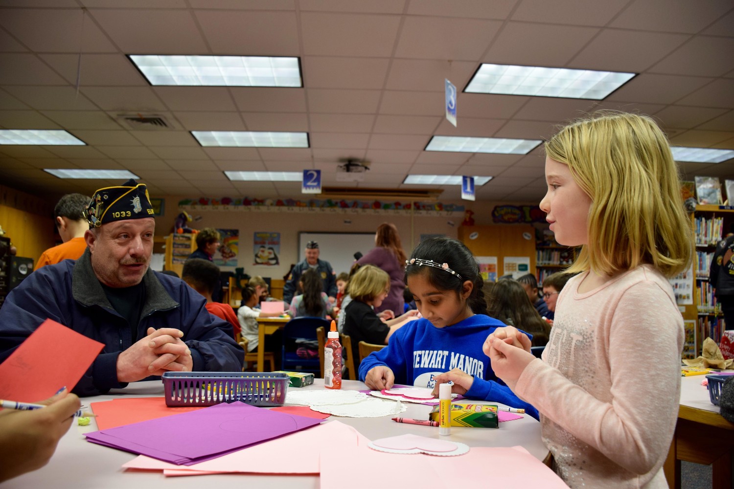 Stewart Manor School fifth-graders Makenna Glynn (right) and Nirvana Moonsammy made Valentine’s Day Cards with U.S. Navy veteran Michael Sweeney