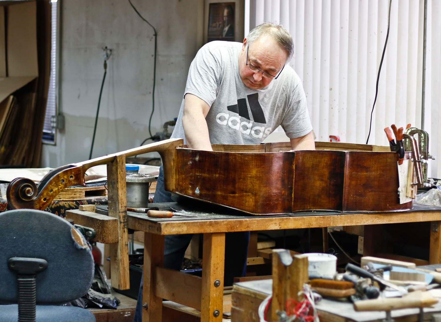 Andy Nerkowski works on the restoration of an older bass.