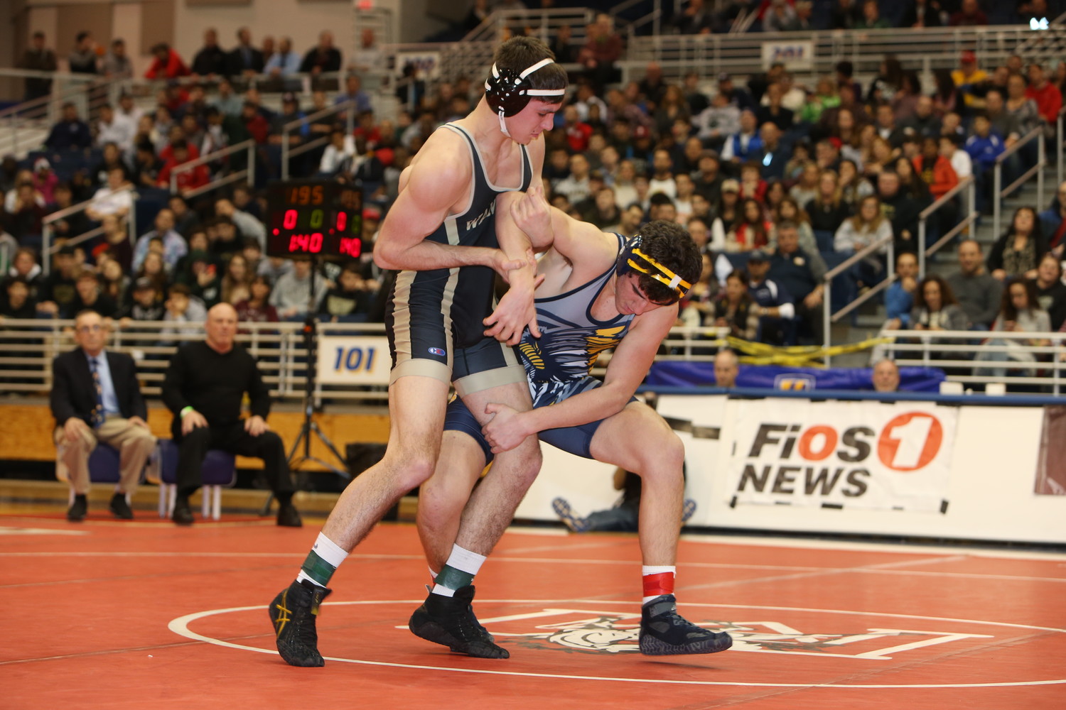 Wantagh’s Jonathan Loew, left, blocked a single leg takedown by Massapequa’s Marco Musso, right, in the first round of the Nassau County Division I wrestling championship’s 195-pound championship match. Loew later won the match via pinfall in the second round.