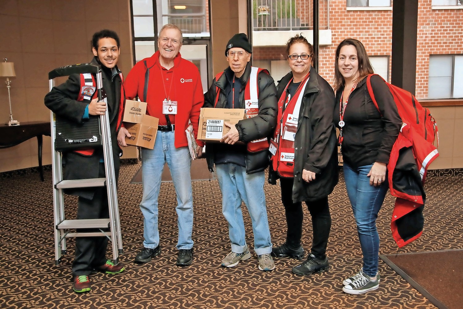 Dominic Jenkins, left, Paul Nulty, Peter King, Karen Serani and Lori-Ann Pizzarelli, helped install smoke alarms on Feb. 24 as volunteers for the American Red Cross.