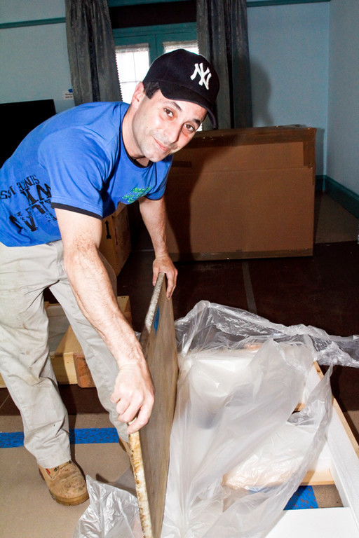 Nick Bamundo unwraps a 50 lb. marble slab that was packed in a special casing while it was being shipped.