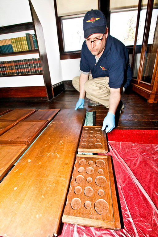 Alfred Zuniga helps put together a cabinet that was also used to house TR's coins in secret drawers that would slide inside  the actual shelf.