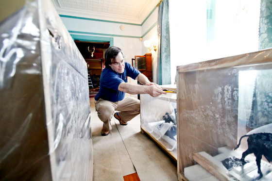 May 5, 2015. In the Drawing Room, George Hagerty cuts open one of the custom crafted shipping containers built to protect the bronze it holds inside.