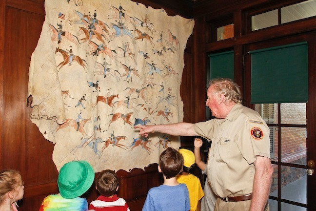 The children listened intently to Brendan Casey, a guide since 1994, as he shared information on the buffalo robe that was painted by Indians given to TR when he was out west. The robe depicts the Battle of Little Bighorn.