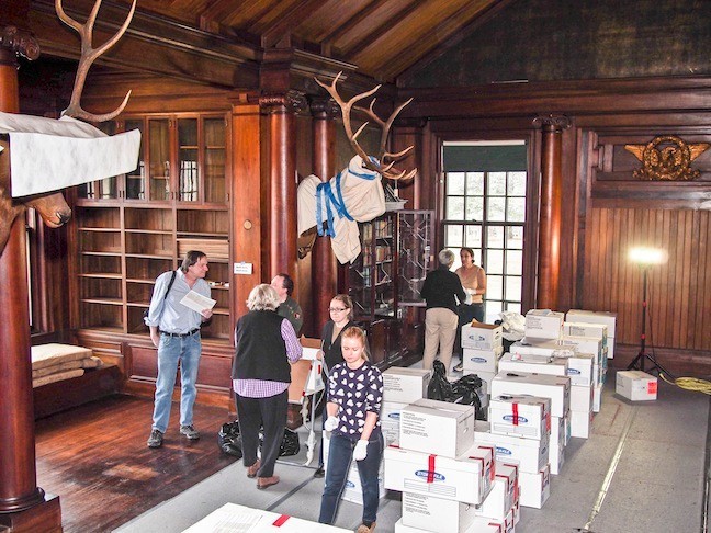 March of 2015.  Workers and volunteers continued to put items back in the North Room. Boxes of books need to be replaced in bookcases exactly where they had been before the restoration.