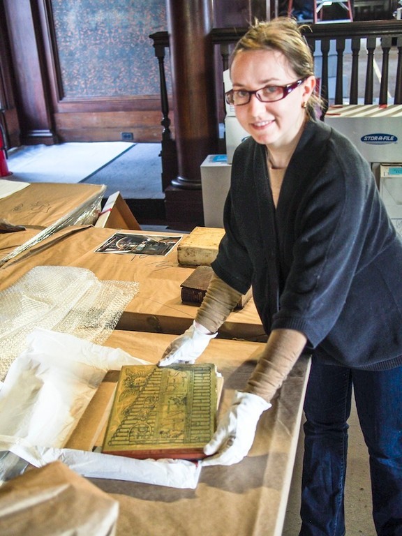 Sag. Hill House Archivist - Betsy DeMaria handles one of the thousands(?) of books returned from archive for placement in the North Room of Sagamore Hill. Books need to be replaced in bookcases in the specific order in which they were removed.