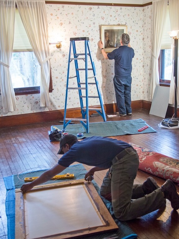 workers from U.S.ART rehng painting in "Big Guest Room" rehanging art work on exact locations from which they were removed.
