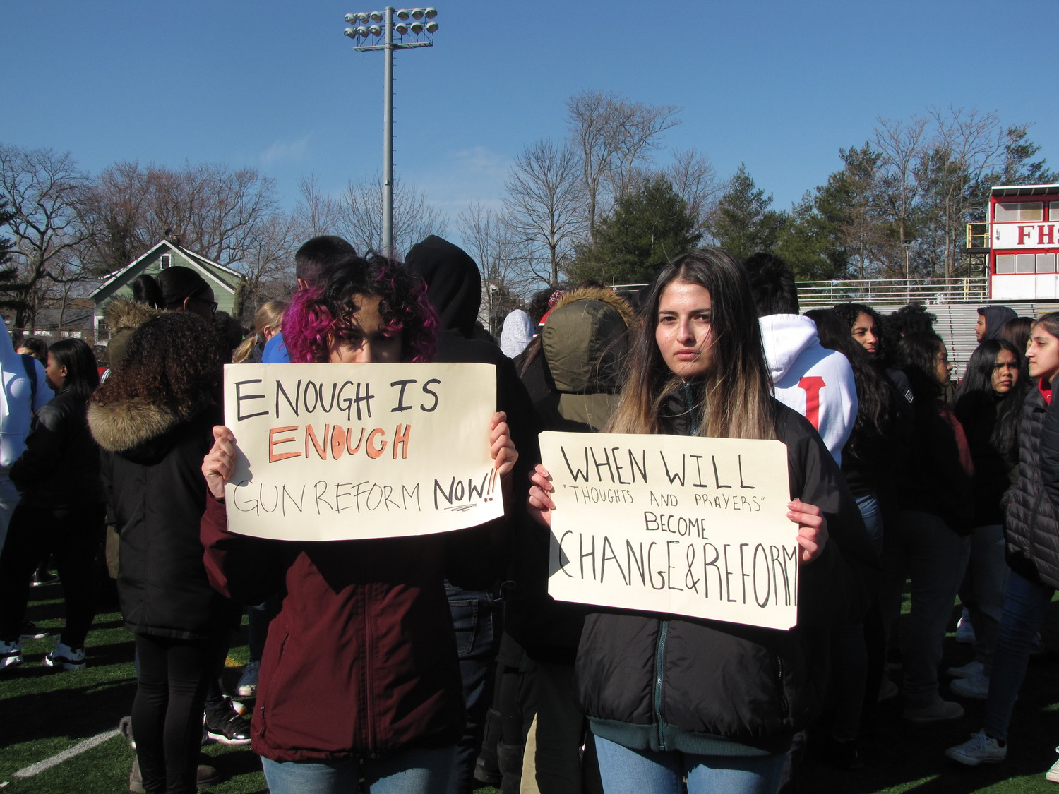 Junior, Leah Hochman, left and senior, Michelle Luongo, right, held hand-made signs to spread awareness.