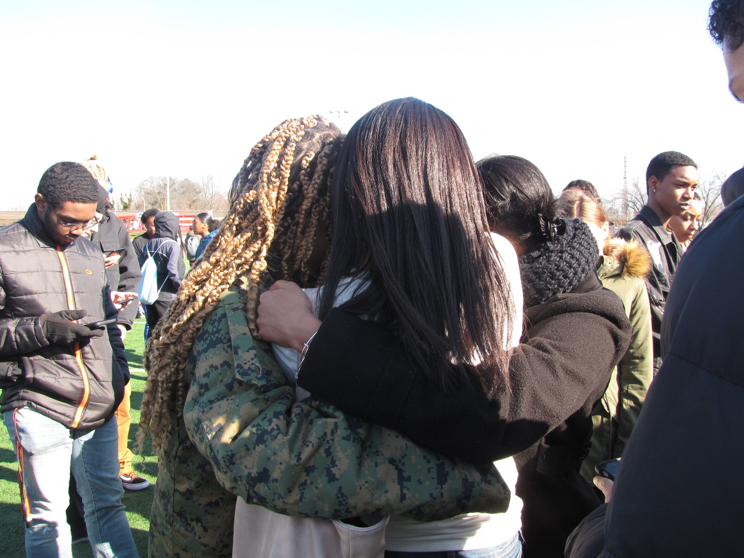 Seniors, Kira Brizill, Nia Mathews and Kayla Sewer consoled each other during the National School Walk Out on March 14.