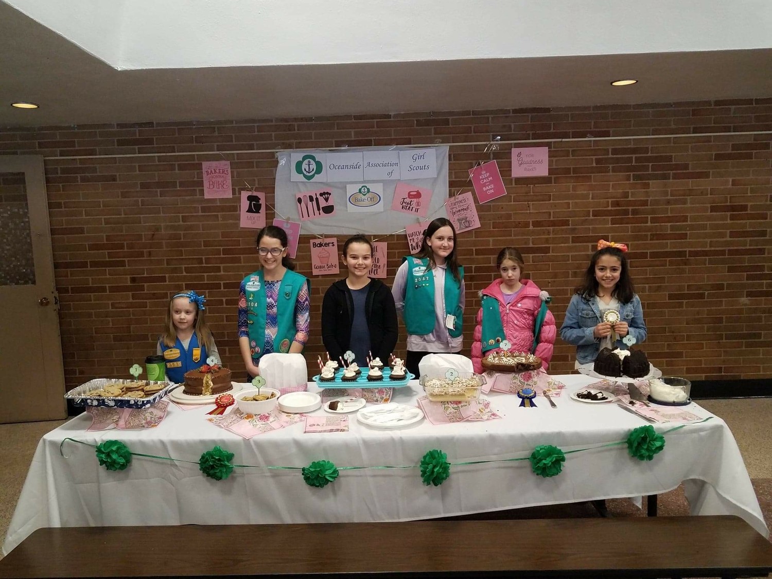 Oceanside Girl Scout members, Lilly Miller, left, Kaitlyn Rey, Riley Brasch, Kylee Griffin, Skylar Parker and Eliana de la Teja with their submitted cakes for the bake off.