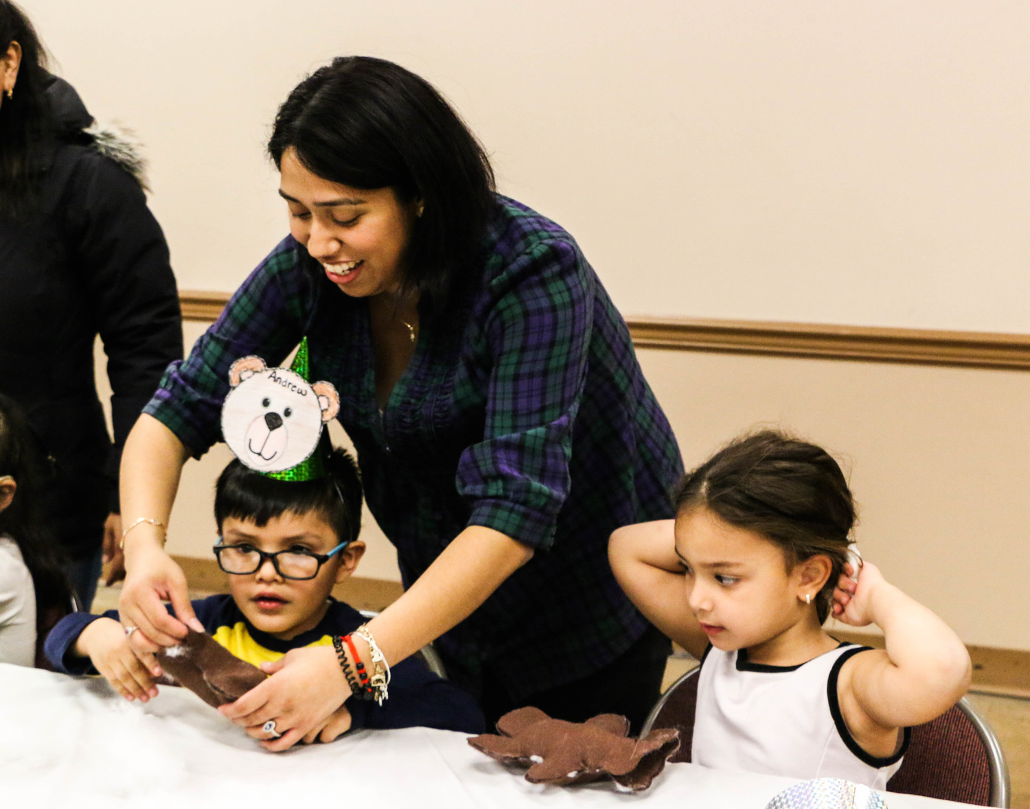 Librarian Georgina Rivas-Martinez helped Andrew Chombo, left, 4, stitch his bear, while Emily Perez, 4, right looked on.