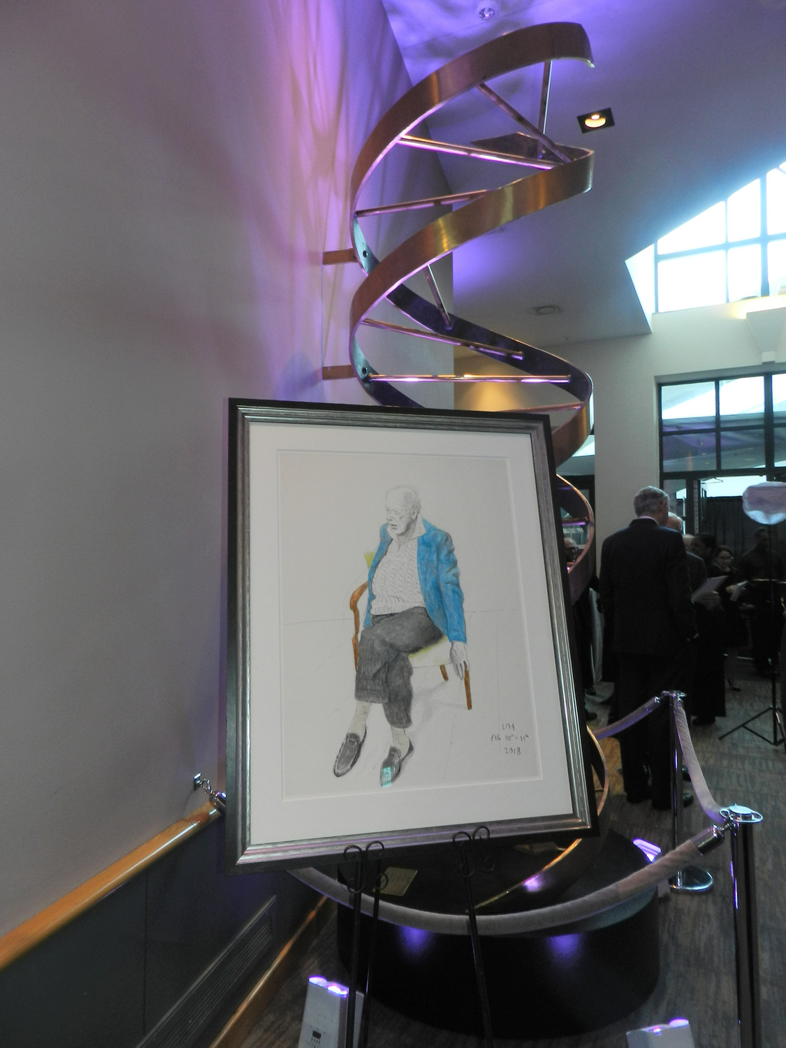 A drawing by David Hockney depicting Dr. Watson, alongside a steel structure of DNA, was displayed in the cocktail area during the party.