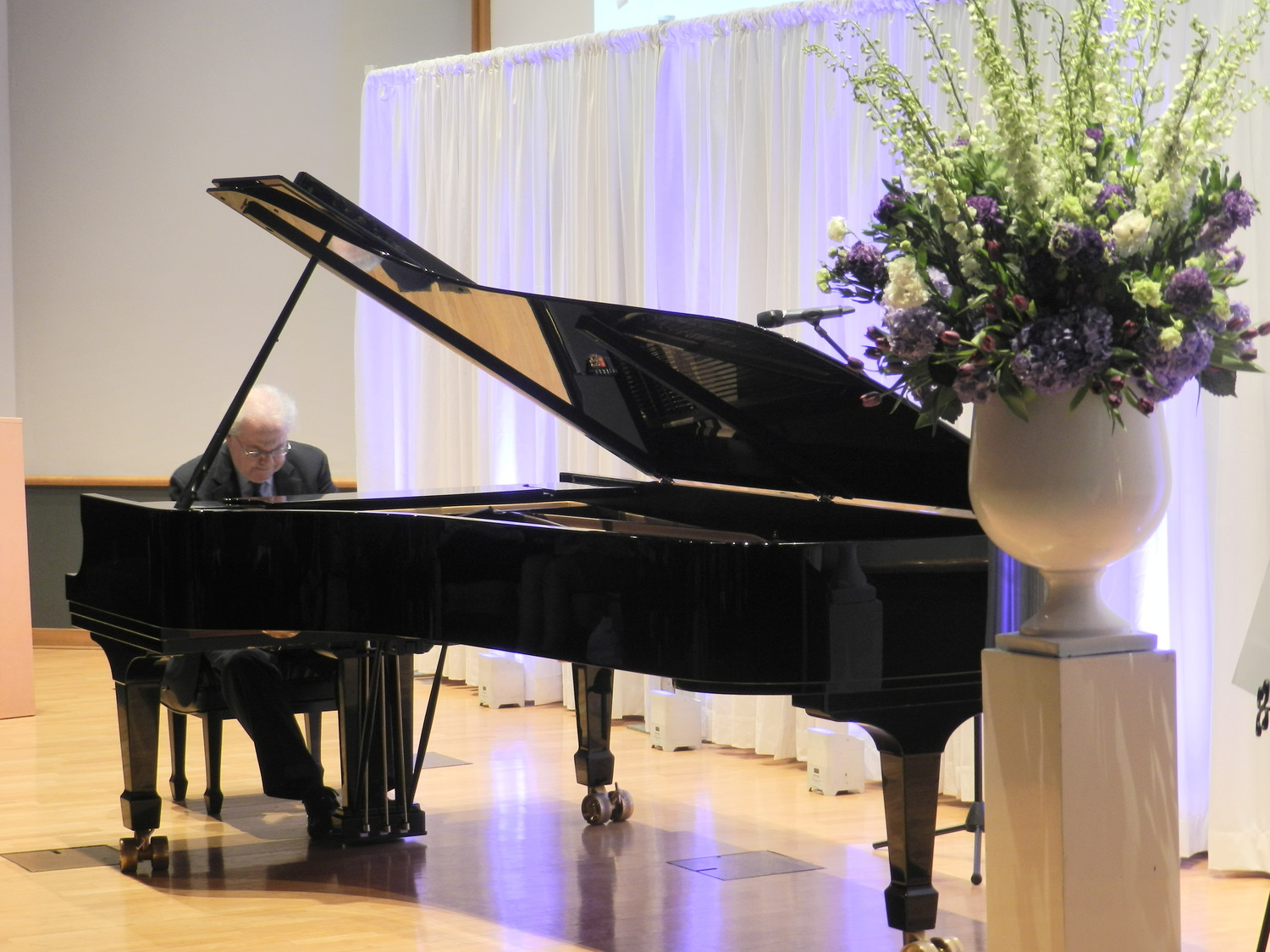 Classical pianist Emanuel Ax performed a few numbers for party guests as a gift to Dr. Watson