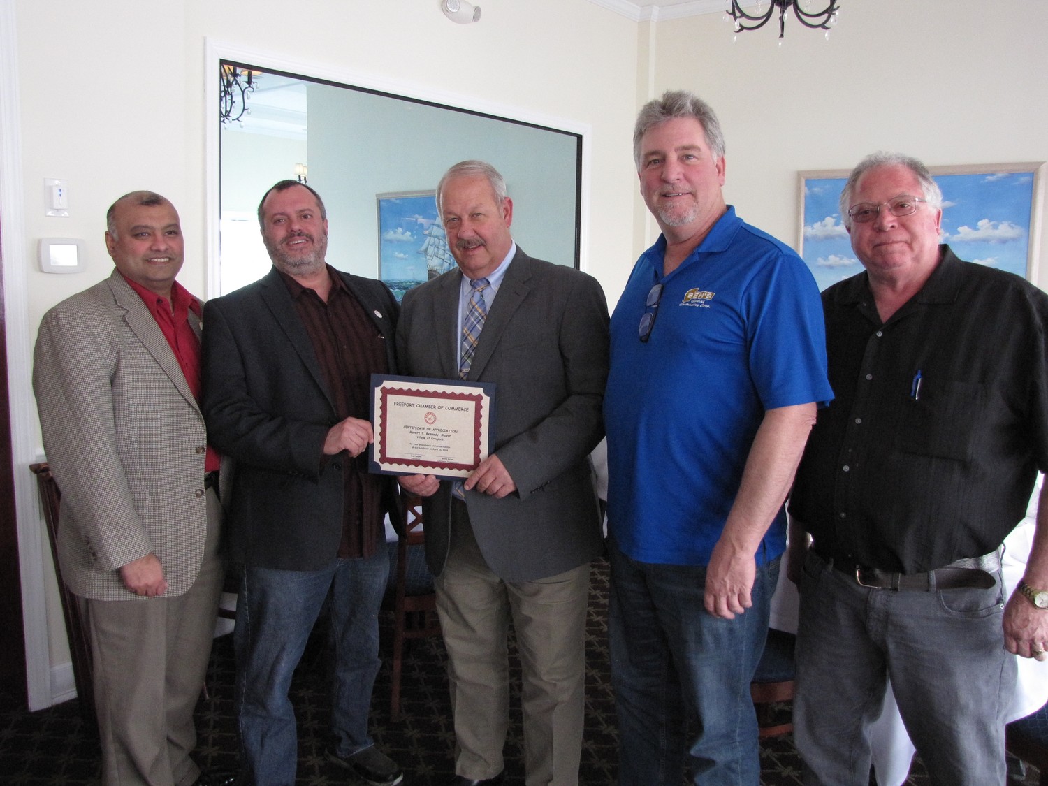 Freeport Mayor Robert Kennedy, center, received a citation from Chamber of Commerce members, from left, Ken Dookram, President Ivan Sayles, Ben Jackson and Thomas Dipolito at a luncheon on the Nautical Mile on Tuesday.