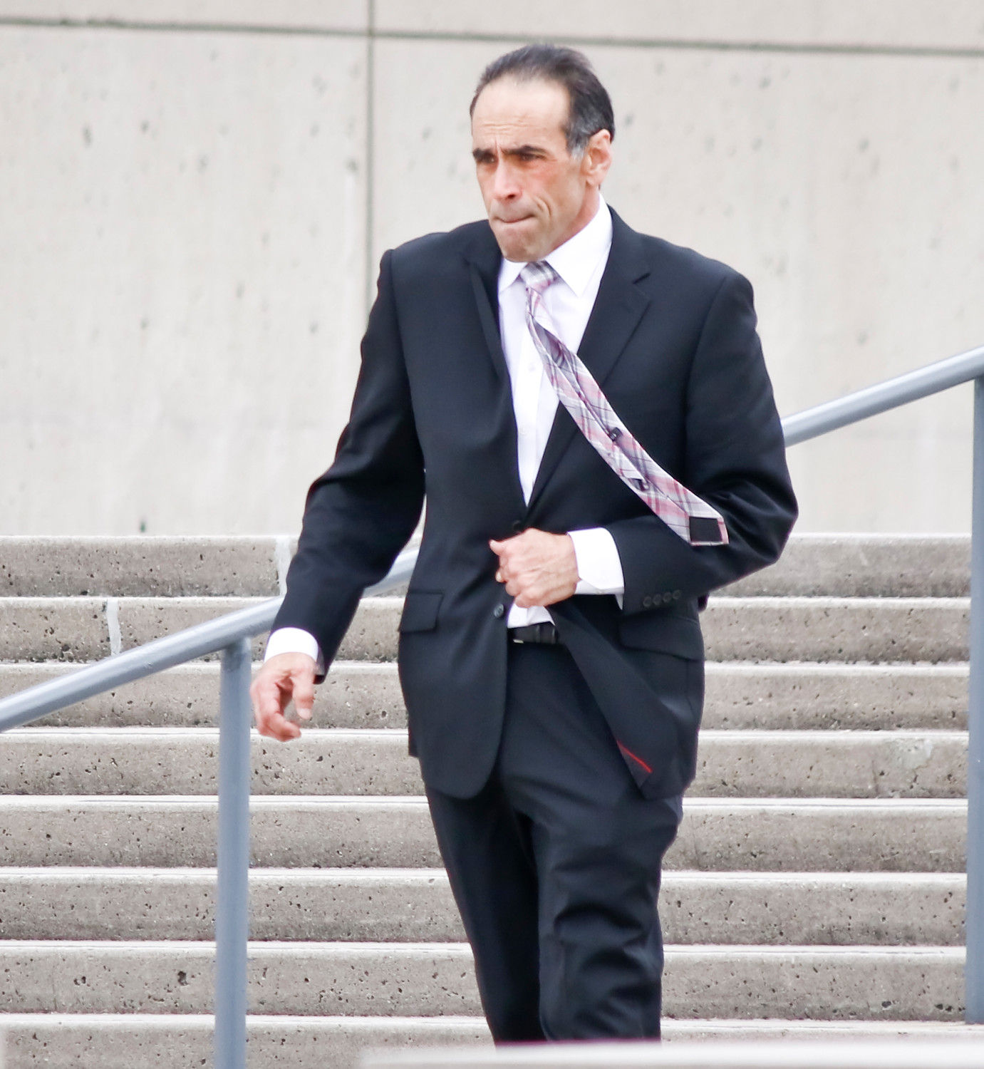 Dr. Michael Belfiore walked out of U.S. District Court in Central Islip on Tuesday. He is on trial for allegedly overprescribing opioids and causing the overdose deaths of two men, and was implicated, but not charged, in the death of another.