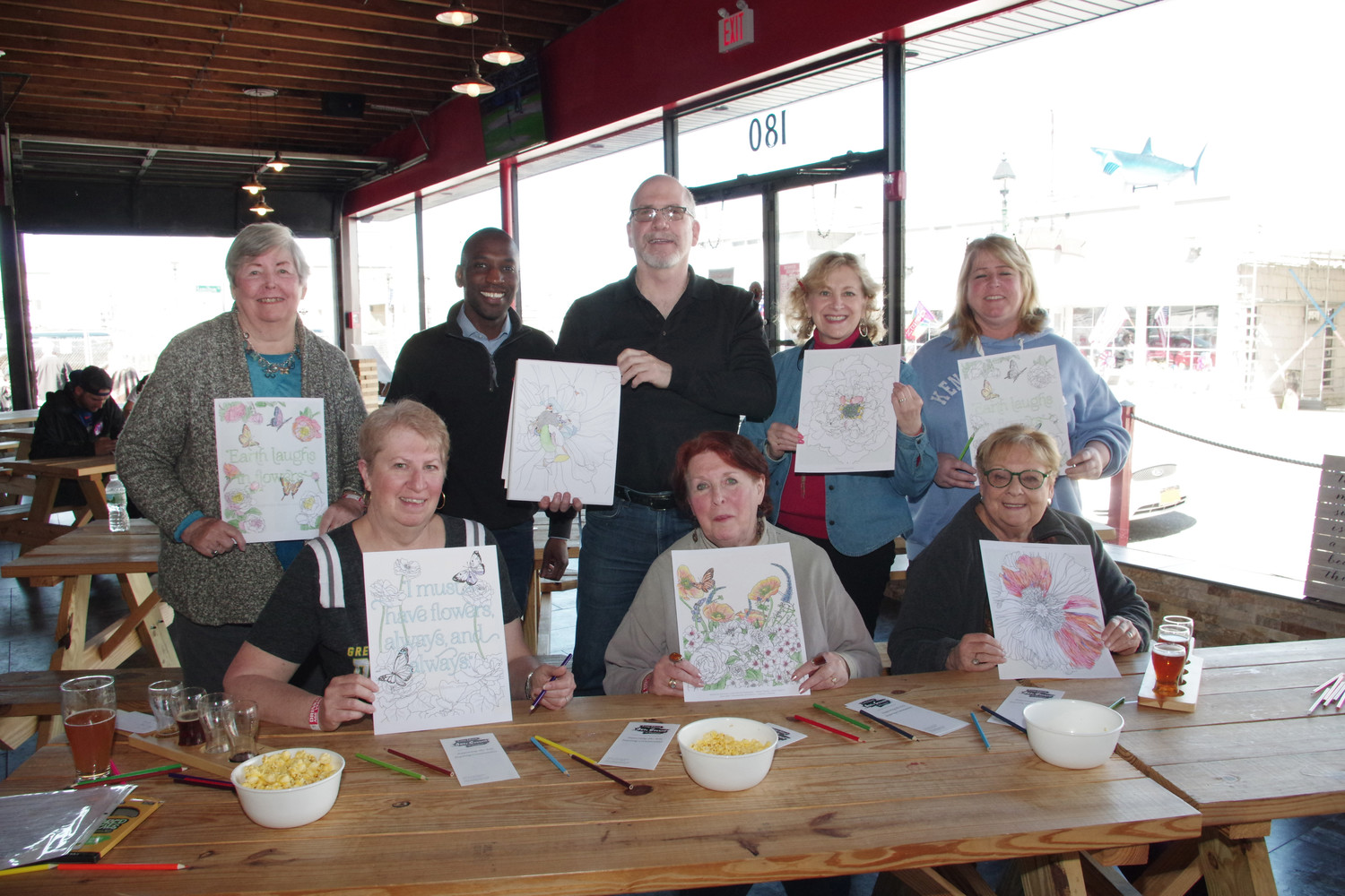Long Island Arts Council at Freeport showed their finish coloring pages during the fundraiser at the BrewSa Brewery, from left, Janet Gabler, Anthony Miller, Larry Dresner, Michelle Berger, Sharon Gabler, Diane Stratton, Lois Howes and Mirelli Taub.