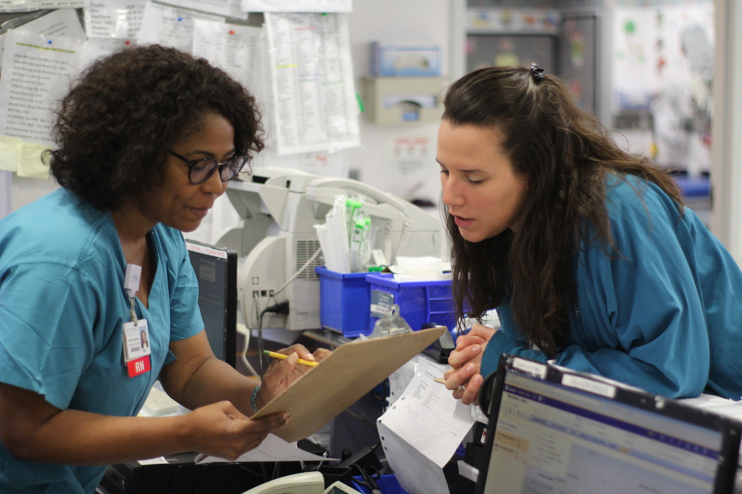 Martine Marsan, a nurse assistant manager at NYU Winthrop Hospital, left, consulted with one of her fellow nurses in the Ambulatory Surgical Unit/Post-Anesthesia Care Unit.