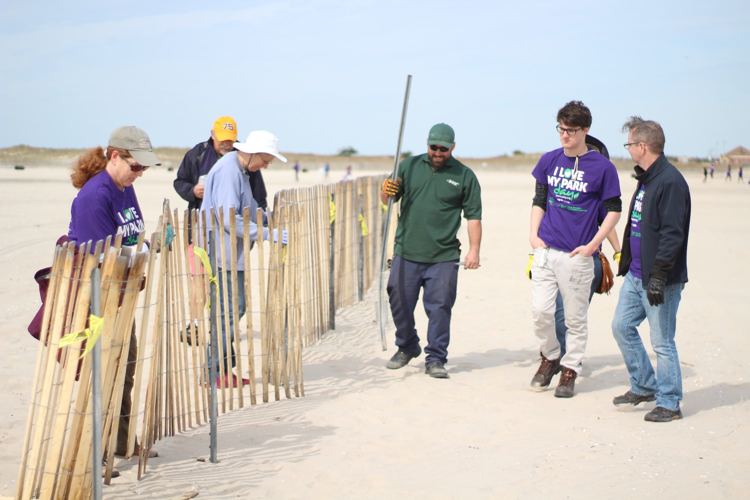 Jones Beach State Park supervisors and volunteers set up snow fencing, which is used to make sand dunes and creates an emergency lane for the upcoming air show.