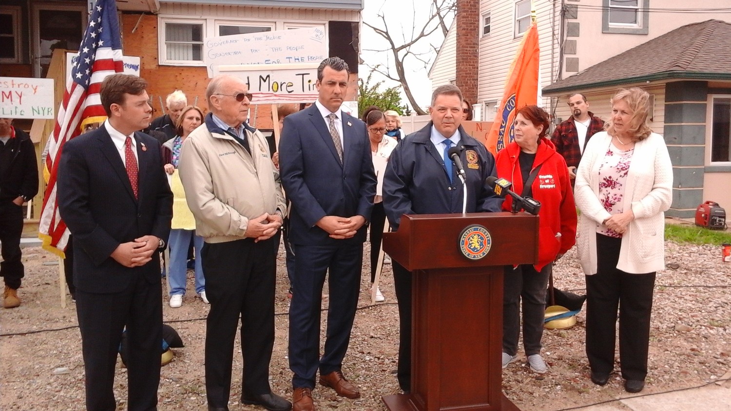County legislators Steve Rhoads, at lectern, held a news conference last Friday to call on the state to extend its home elevation deadlines. It did so only hours after the gathering.